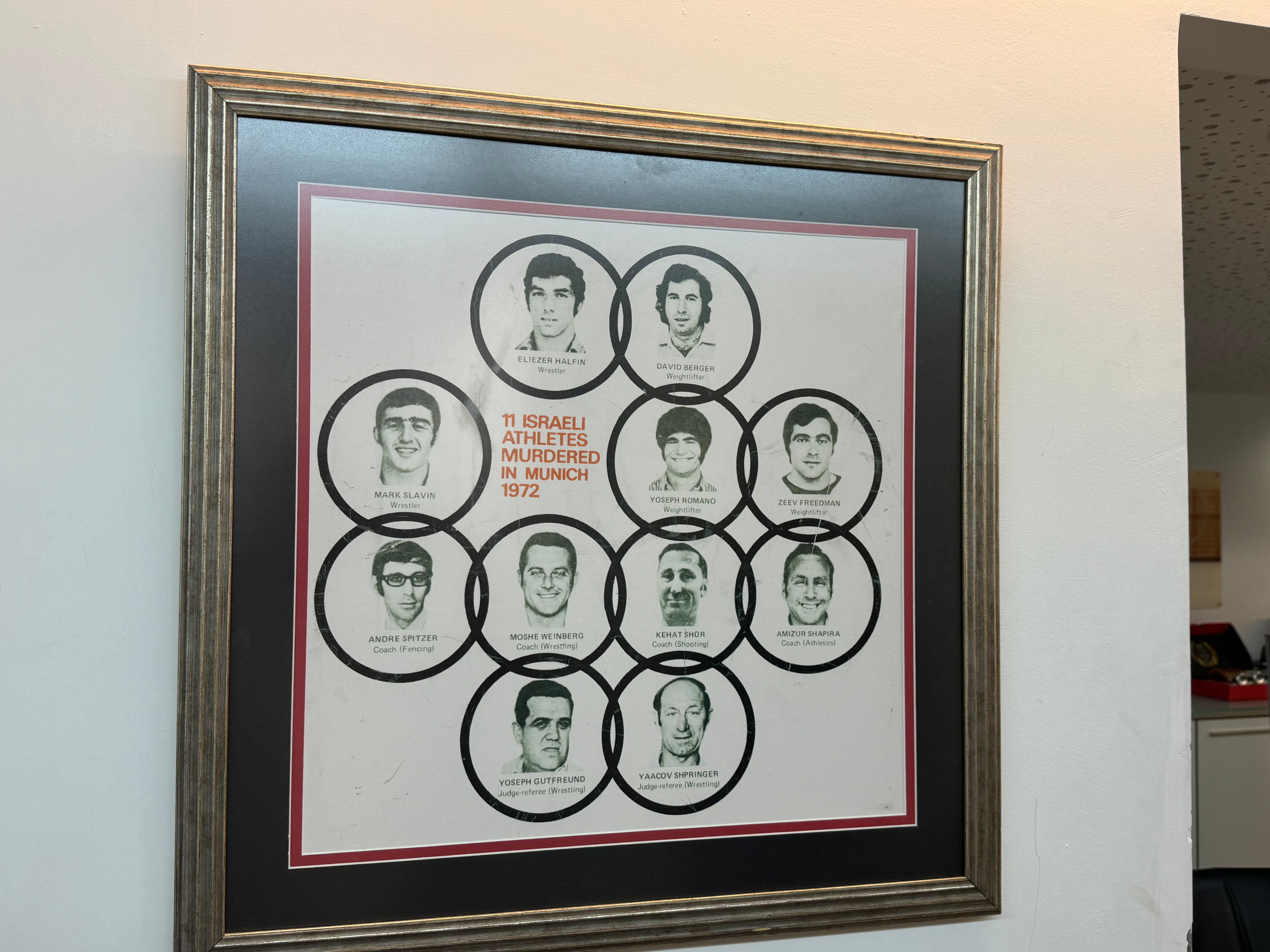 A framed photo of the 11 Israeli athletes who were murdered by Palestinian terrorists in the Munich Olympics in 1972 hangs on the wall of the Israeli Olympic Committee headquarters in Tel Aviv.